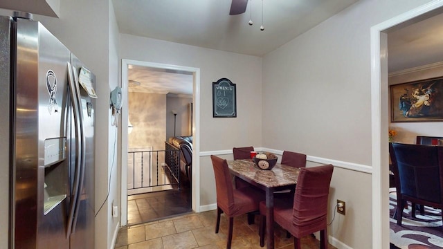 dining area featuring baseboards, stone finish flooring, and ceiling fan