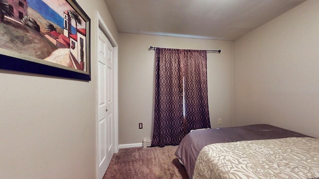 bedroom featuring a baseboard heating unit, carpet flooring, and baseboards