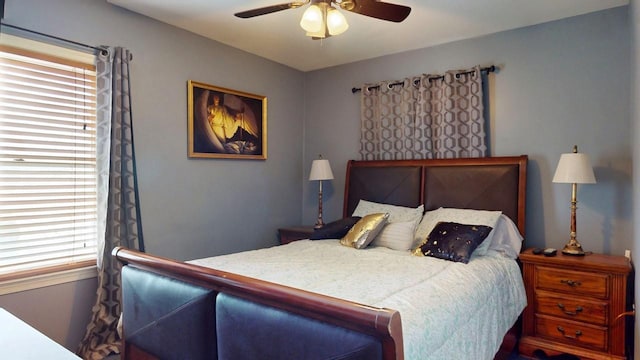 bedroom featuring multiple windows and ceiling fan