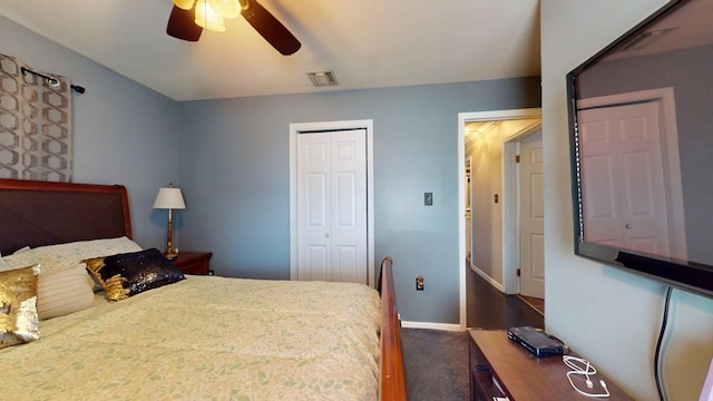 bedroom with visible vents, ceiling fan, baseboards, a closet, and dark colored carpet