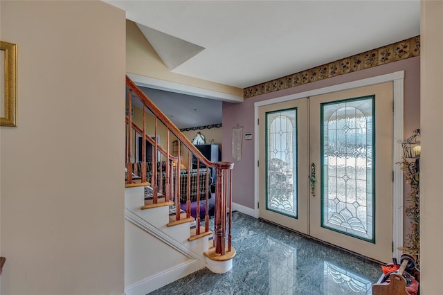 foyer entrance featuring stairs, marble finish floor, french doors, and baseboards