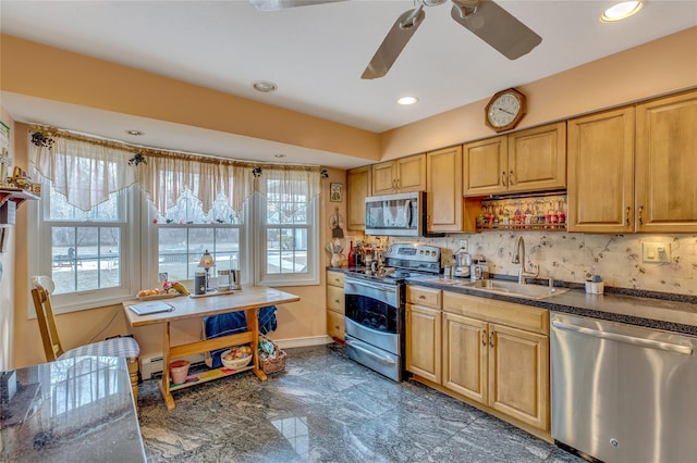 kitchen with recessed lighting, a sink, baseboards, appliances with stainless steel finishes, and tasteful backsplash