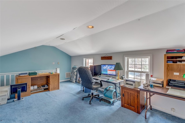 carpeted office with visible vents, baseboards, and vaulted ceiling