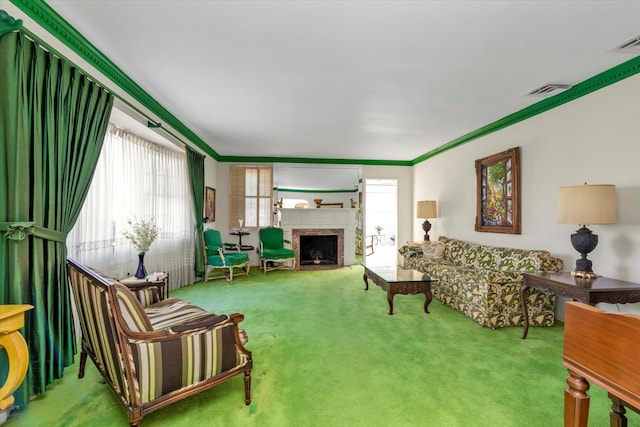 carpeted living room featuring crown molding, a fireplace, and visible vents