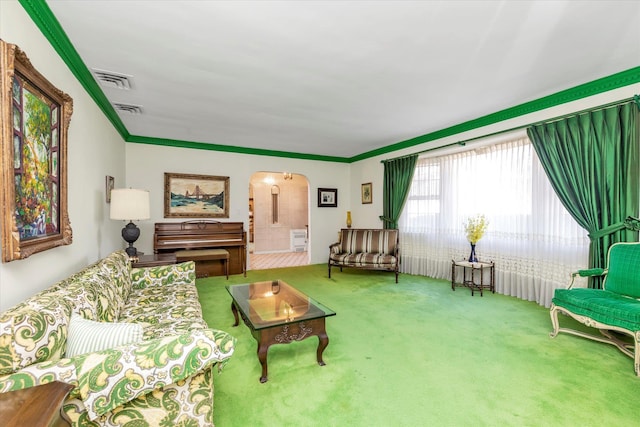 living room with visible vents, arched walkways, carpet floors, and ornamental molding