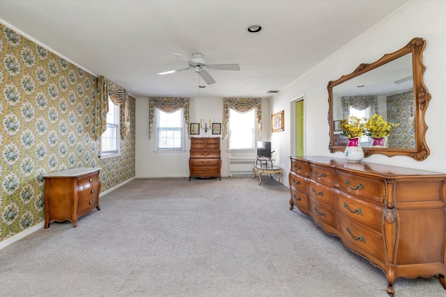 bedroom featuring radiator, wallpapered walls, baseboards, ceiling fan, and light colored carpet