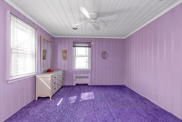 unfurnished bedroom featuring radiator, wood ceiling, ceiling fan, and carpet flooring