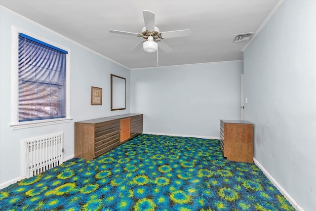 spare room featuring visible vents, carpet flooring, ceiling fan, and crown molding