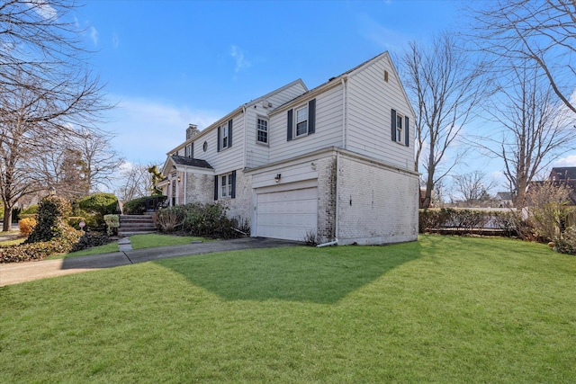 view of side of property featuring a chimney, a garage, aphalt driveway, a lawn, and brick siding