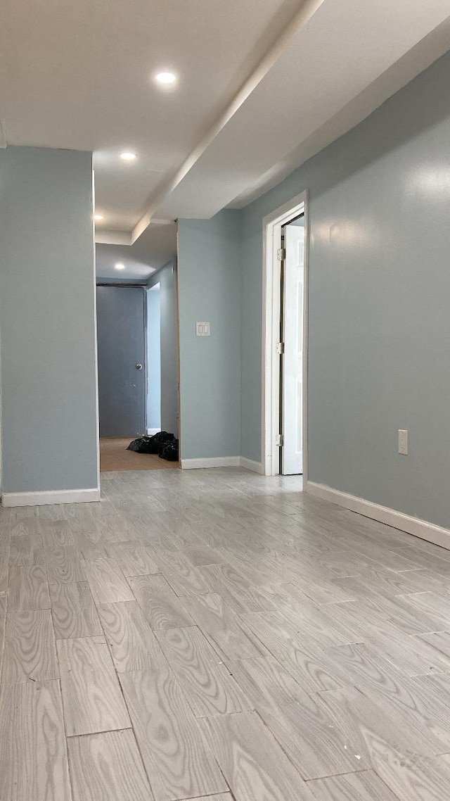 spare room featuring light wood-style flooring and baseboards