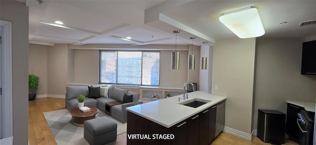 kitchen featuring visible vents, coffered ceiling, a sink, light countertops, and black range with electric stovetop