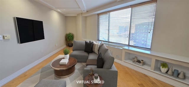 sitting room with baseboards and wood finished floors