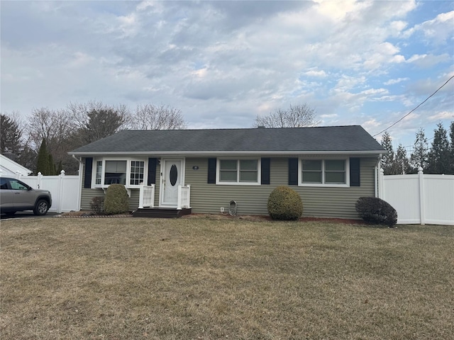 ranch-style house with a front yard, fence, and a shingled roof