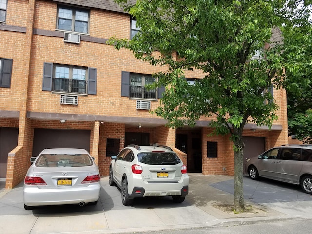 view of building exterior featuring driveway and an attached garage