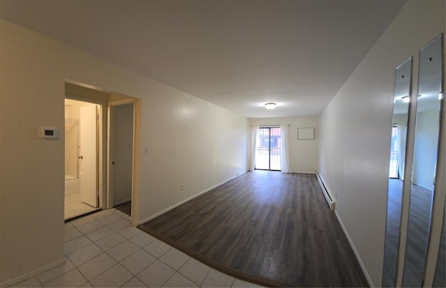 tiled empty room featuring baseboards