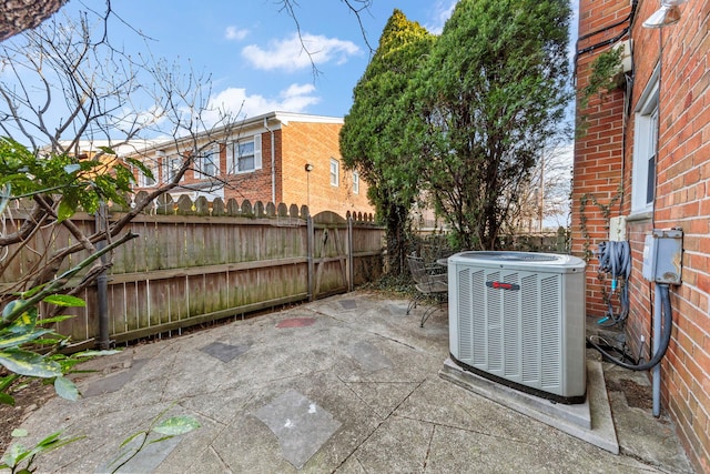 view of patio / terrace with central air condition unit and fence private yard