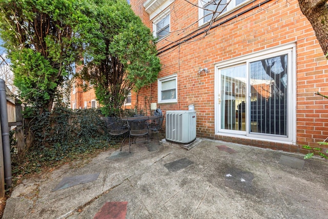 view of patio featuring central AC unit and fence