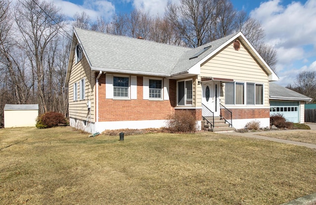 view of front of house featuring a front yard, brick siding, and an attached garage