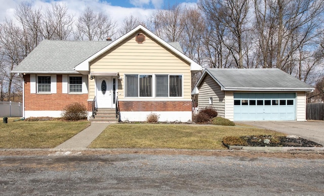 view of front of home with a front yard, fence, roof with shingles, a garage, and brick siding