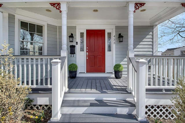 view of exterior entry featuring a porch