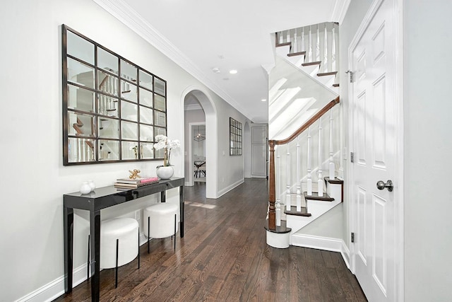 entrance foyer with stairway, baseboards, arched walkways, dark wood-style flooring, and crown molding