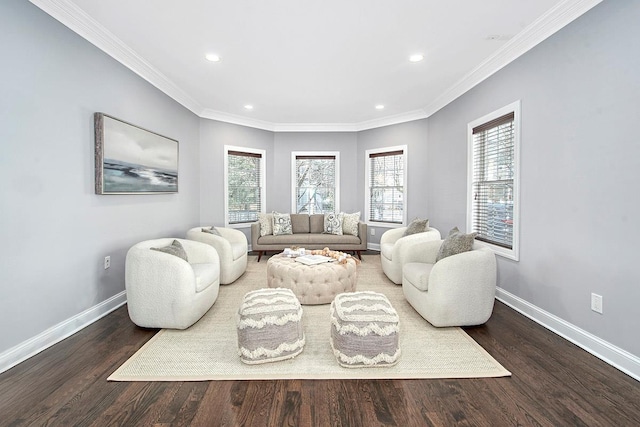 living area featuring baseboards, wood finished floors, and crown molding