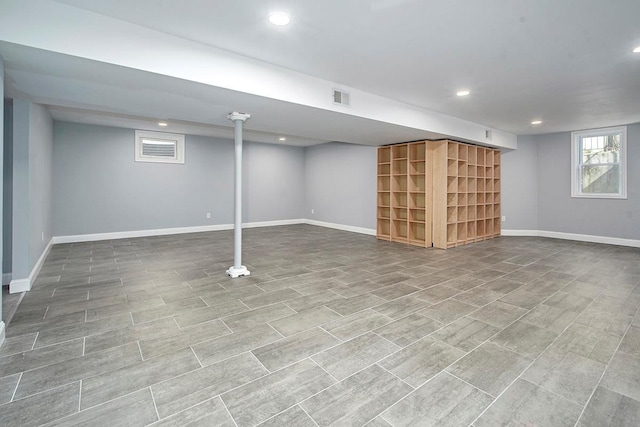 below grade area featuring recessed lighting, visible vents, and baseboards