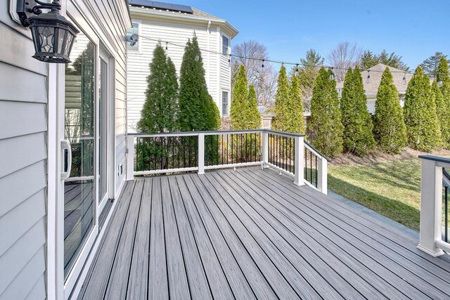 wooden terrace with a lawn