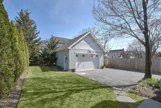 garage with fence and driveway