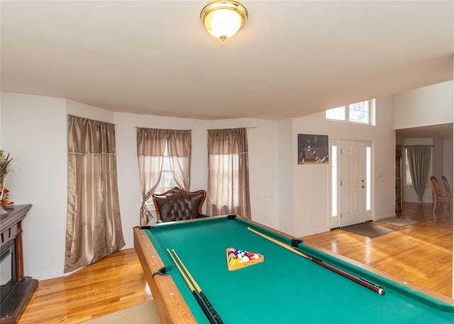 game room with light wood finished floors, pool table, baseboards, and a wealth of natural light