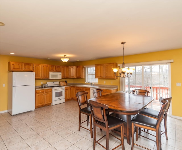 dining room with a notable chandelier, recessed lighting, baseboards, and light tile patterned floors