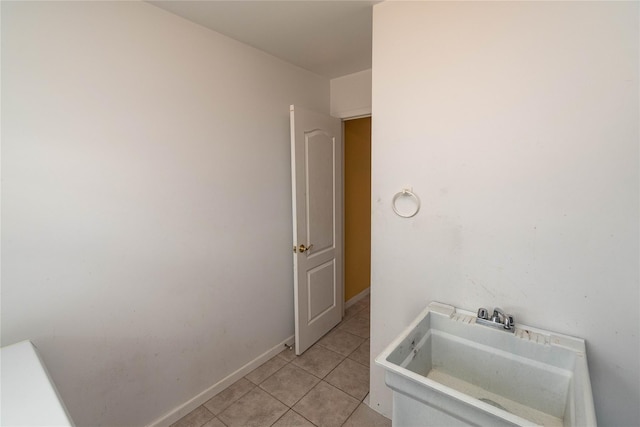 bathroom featuring a sink, baseboards, and tile patterned flooring