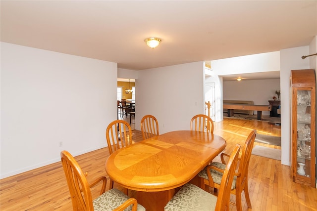 dining room with light wood-style floors and baseboards