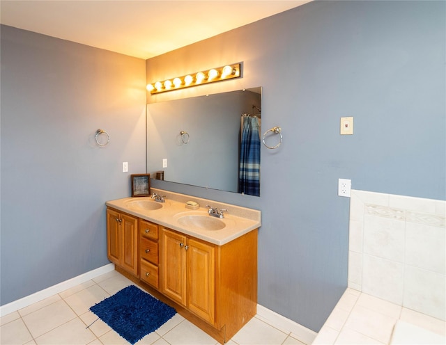 bathroom with tile patterned flooring, double vanity, and a sink