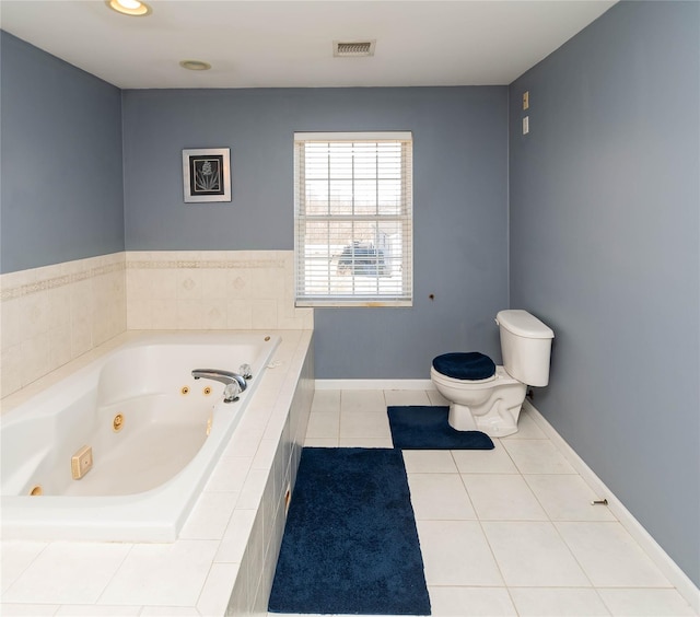 full bathroom featuring tile patterned flooring, visible vents, baseboards, toilet, and a tub with jets