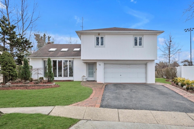 view of front of house with roof with shingles, a chimney, a front lawn, a garage, and aphalt driveway