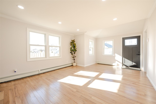 foyer featuring ornamental molding, a baseboard heating unit, recessed lighting, light wood-style floors, and baseboards