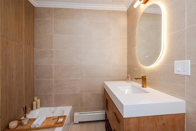 full bath with vanity, a tub to relax in, a baseboard radiator, ornamental molding, and tile walls