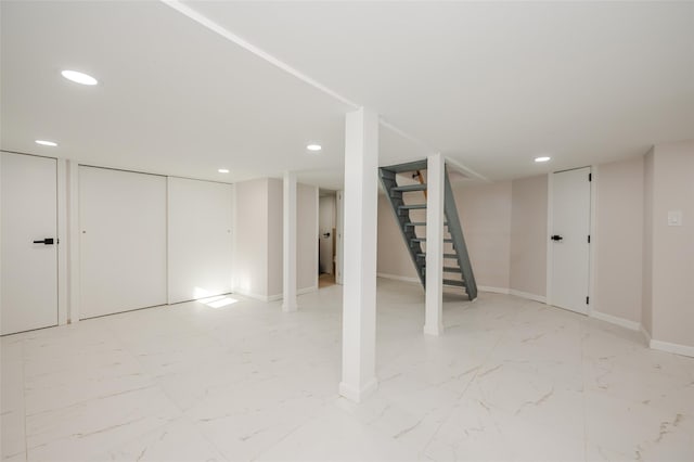 finished below grade area featuring recessed lighting, baseboards, marble finish floor, and stairs