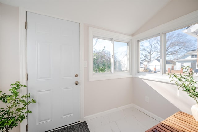 doorway to outside featuring baseboards, lofted ceiling, and marble finish floor