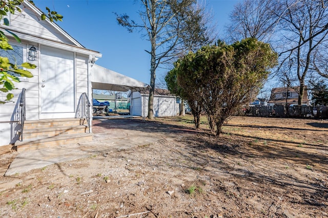 view of yard featuring an outbuilding and fence