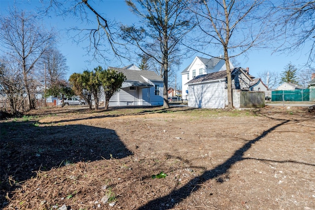 view of yard featuring an outdoor structure and fence