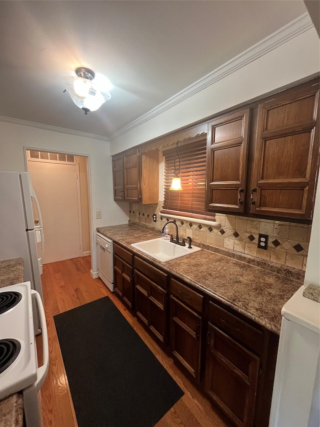 27 Sycamore Dr Bldg 2A, Middletown, NY 10940 - kitchen featuring backsplash, crown molding, light wood-style floors, white appliances, and a sink