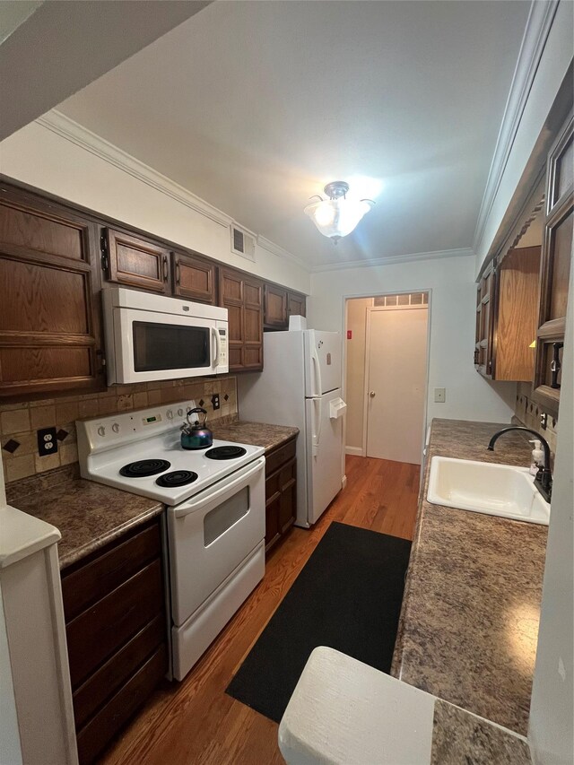 27 Sycamore Dr Bldg 2A, Middletown, NY 10940 - kitchen featuring light wood-type flooring, visible vents, ornamental molding, a sink, and white appliances