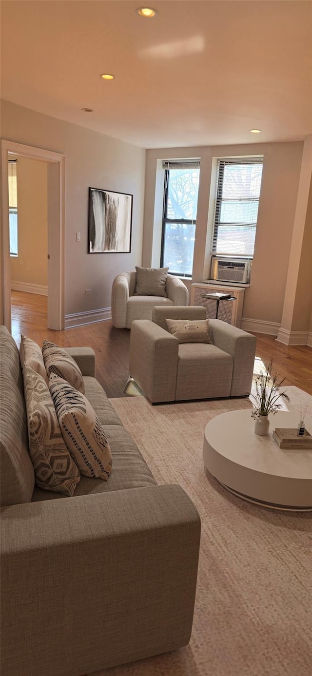 living room with recessed lighting, baseboards, and wood finished floors