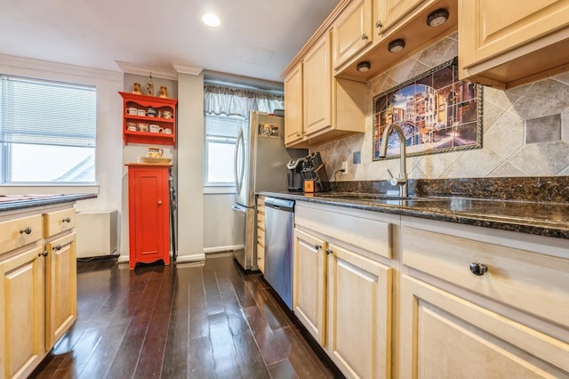 kitchen with light brown cabinets, a sink, dark wood-type flooring, dishwasher, and tasteful backsplash