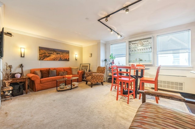 carpeted living room featuring visible vents, track lighting, and ornamental molding