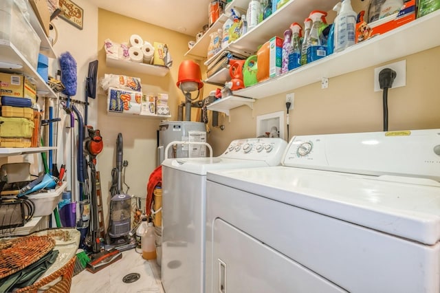 laundry room with laundry area, independent washer and dryer, and electric water heater