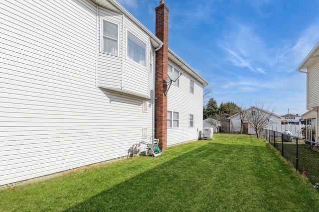 view of yard featuring a fenced backyard and a residential view