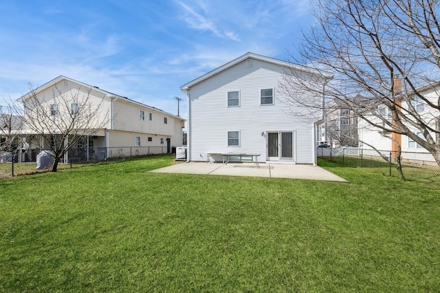 back of house with a patio area, a yard, and a fenced backyard